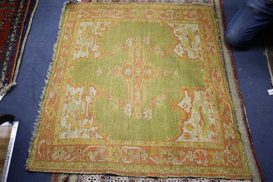 An Antique Turkestan square mat, with central green and red medallion, 108 x 121cm